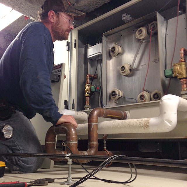 Technician Repairing Electrostatic Cell